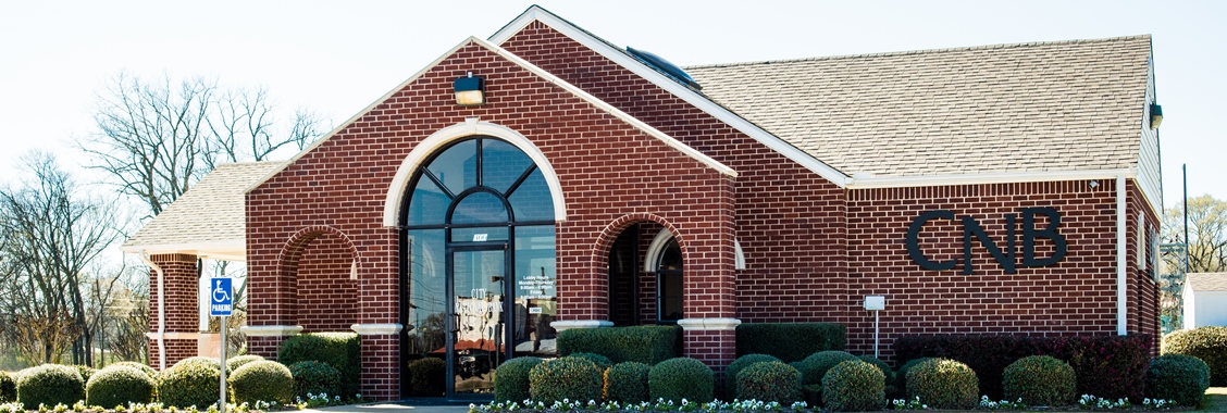 Red brick building with arched doorway windows.